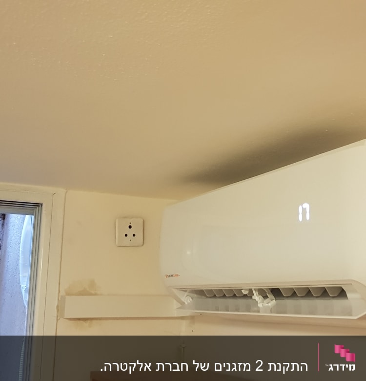 מזגן קיר לבן מותקן על קיר פנימי